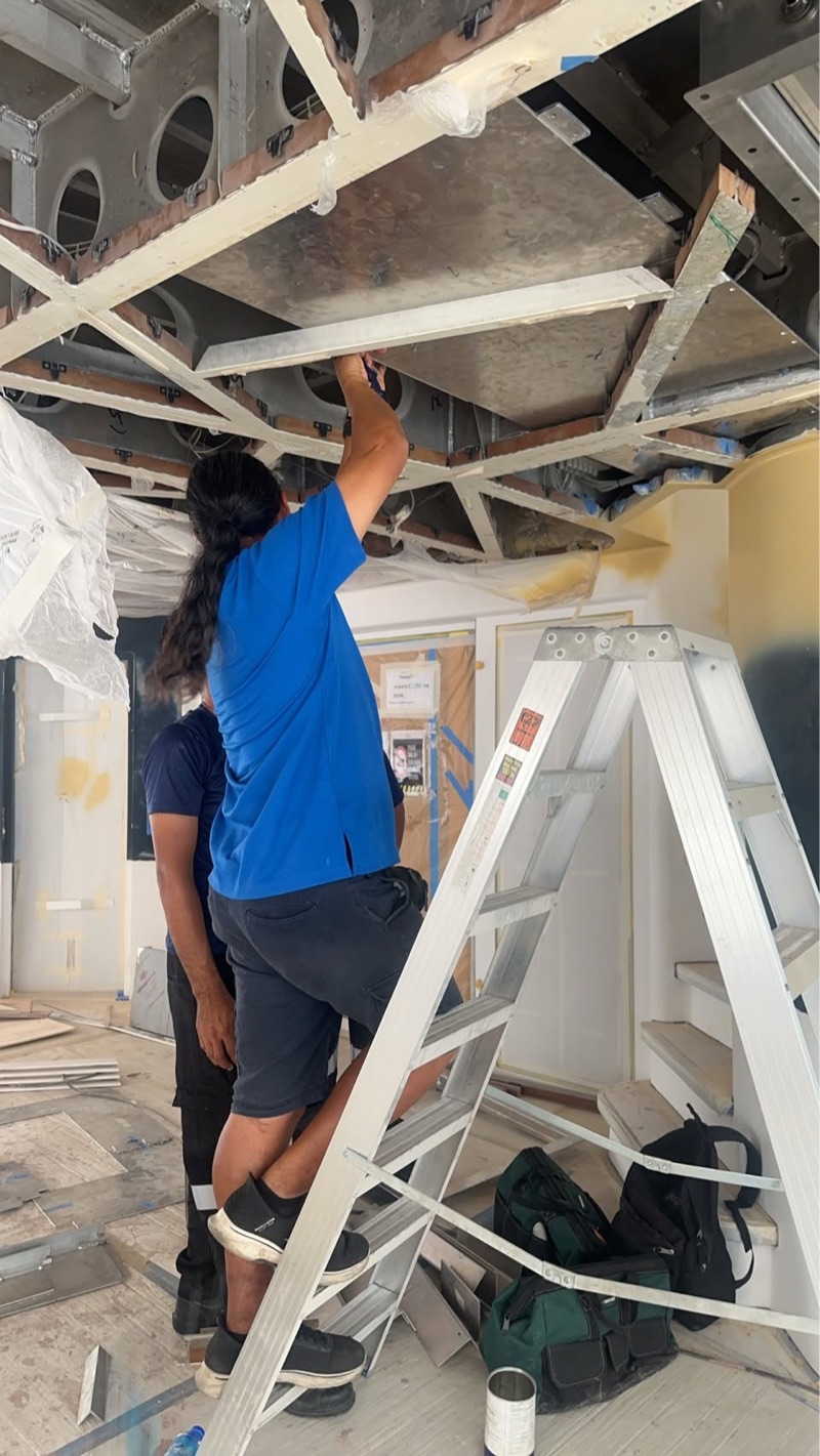 Cirrus technicians installing air-conditioning ducting on board a yacht